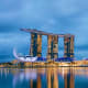 Marina Bay Sands hotel and resort illuminated at dusk with reflection in water, Singapore skyline